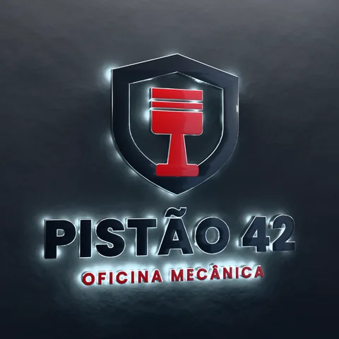 Letreiro da Oficina Pistão 42 com LED numa parede de concreto.
